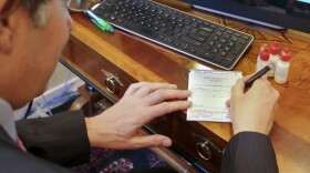 Dr. Michael T. Goldstein, New York County Medical Society President, use a standard prescription pad which is being made obsolete by a new electronic prescription law, Thursday, March 17, 2016, in New York. E-prescribing has surged nationwide in recent years. Every state now allows it, but only New York has a broad requirement that carries penalties. (AP Photo/Bebeto Matthews)