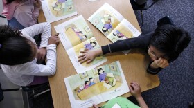 In this photo taken Wednesday, Feb. 6, 2013, Campbell Hill Elementary kindergarten students work on reading skills in Renton, Wash. Washington is one of two states (the other being Pennsylvania) that doesn't require kids to start their educations until age 8. A bill in the House would lower the mandatory age to 6, but would exempt home-schoolers, who wouldn't fall under the state's instructional supervision until age 8.(AP Photo/Elaine Thompson)