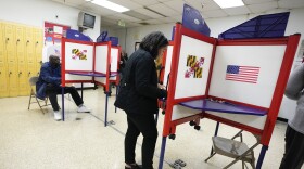 FILE - People fill out ballots during early voting at Westside Skill Center, Oct. 31, 2022, in Baltimore, Md. Midterm elections are being held on Tuesday, Nov. 8. (AP Photo/Julio Cortez, File)