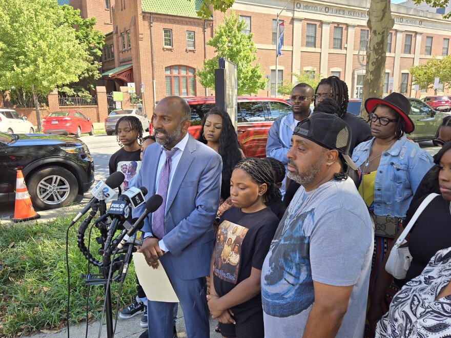 Thiru Vignarajah (center) speaks to reporters on Monday Aug. 12, 2024 surrounded by the family of Ronald Silver II