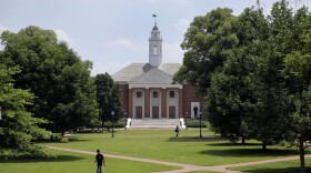 FILE - In this July 8, 2014 file photo, people walk on Johns Hopkins University's Homewood campus in Baltimore. (AP Photo/Patrick Semansky, File)