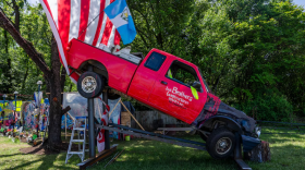 An art installation by Roberto Marquez, who also created a memorial mural for the six men killed in the Key Bridge collapse, features a red truck similar to the one the men were in when the bridge collapsed. (Kaitlin Newman/The Baltimore Banner)