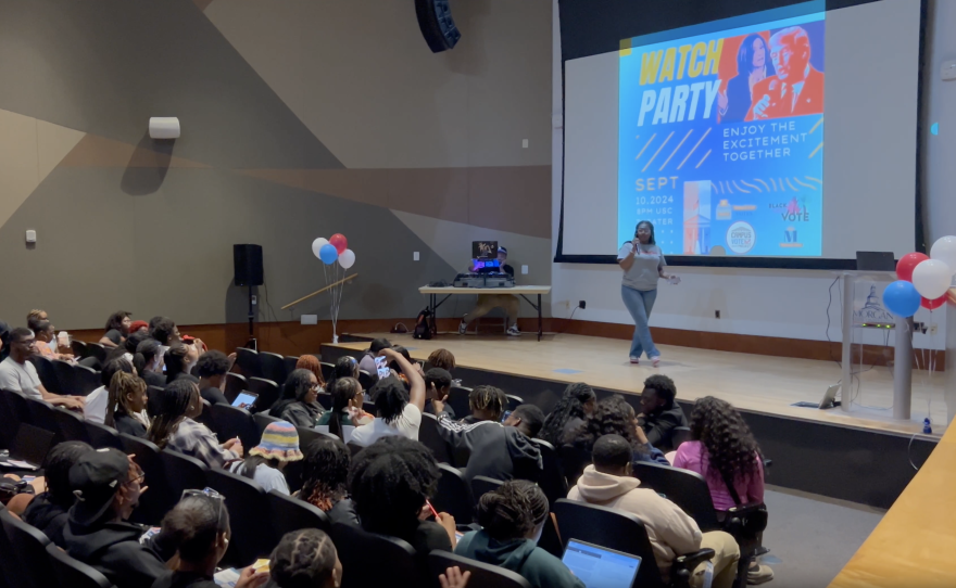 As students entered the University Theater — where the debate was live streamed — a student worker handed out popcorn, while a DJ spun hip hop tunes. Photo by Wambui Kamau/WYPR.