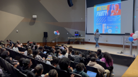 As students entered the University Theater — where the debate was live streamed — a student worker handed out popcorn, while a DJ spun hip hop tunes. Photo by Wambui Kamau/WYPR.