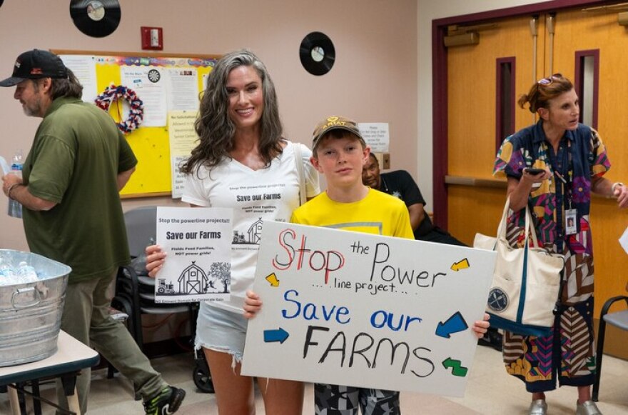 Danielle Konstandindis and Micheal Hicks pose for a photograph at a public information session held by the Maryland Piedmont Reliability Project in Westminster on July 11, 2024. (Ronica Edwards/The Baltimore Banner)