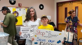 Danielle Konstandindis and Micheal Hicks pose for a photograph at a public information session held by the Maryland Piedmont Reliability Project in Westminster on July 11, 2024. (Ronica Edwards/The Baltimore Banner)