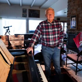 Dr. Robert Fiscella stands next to the Steinway piano that belonged to his late friend, Agi Jambor. (Photo credit Kaitlin Newman, The Baltimore Banner)