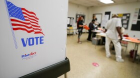 People check in to vote at Edmondson Westside High School during Maryland's primary election, Tuesday, July 19, 2022, in Baltimore. (AP Photo/Julio Cortez)