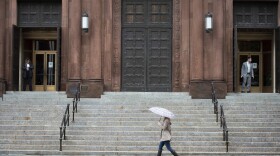 Security officers stand watch as a pedestrian walks by the Roman Catholic Archdiocese of Washington's Red Mass at Cathedral of St. Matthew the Apostle in Washington, D.C., Sunday, Oct. 2, 2022. The annual Mass invokes guidance on members of the legal profession. (AP Photo/Cliff Owen)