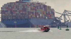 A container ship rests against wreckage of the Francis Scott Key Bridge on Wednesday, March 27, 2024, in Baltimore, Md. The ship rammed into the major bridge in Baltimore early Tuesday, causing it to collapse in a matter of seconds and creating a terrifying scene as several vehicles plunged into the chilly river below. (AP Photo/Matt Rourke)