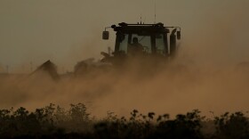 FILE - Dust flies as a farmer plows over a failed cotton field, Oct. 4, 2022, in Halfway, Texas. Drought and extreme heat have severely damaged much of the cotton harvest in the U.S., which produces roughly 35% of the world's crop. The impacts of climate change hit communities across the country, yet voters in rural areas are the least likely to feel Washington is in their corner on the issue. (AP Photo/Eric Gay, File)