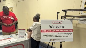 A woman signs into the Open House Meeting. Photo by Emily Hofstaedter/WYPR. 