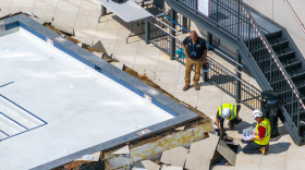 Baltimore firefighters and engineers examine the building's pool after it leaked and the deck appeared to buckle.(Jerry Jackson/The Baltimore Banner)