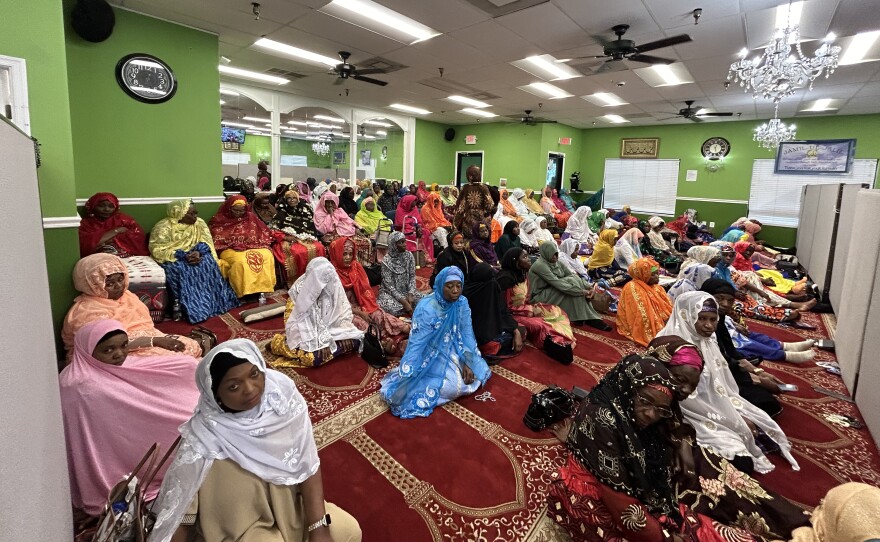 The women who sit in a separate area, listen as well. "The men are the head, but the women at the neck of the family," said Haja Dumbuya, a leader at the Islamic center. " Wherever the the head turns, it's because of the neck that is turning around. So they carry the the load of all what's going on."