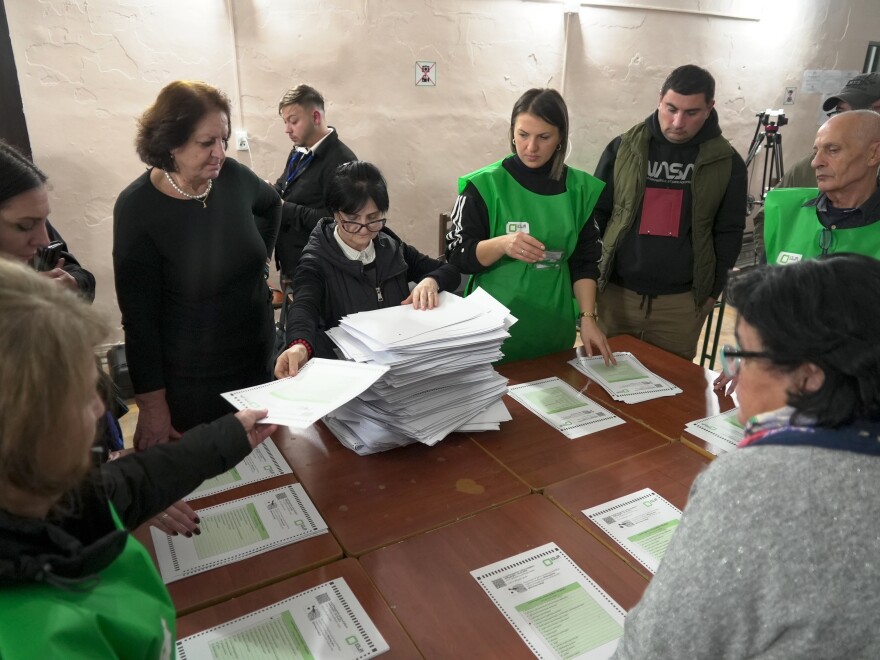 Members of an election commission count ballots at a polling station after the parliamentary election in Tbilisi, Georgia on Saturday.