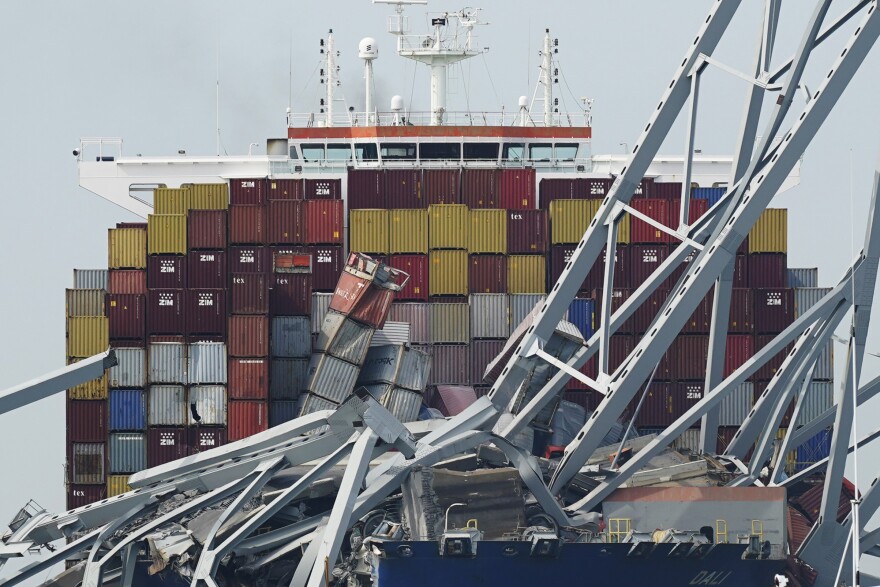 FILE - The container ship Dali is stuck under part of the Francis Scott Key Bridge after the ship hit the bridge Tuesday March 26, 2024, in Baltimore, Md. (AP Photo/Steve Helber, File)