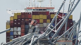 FILE - The container ship Dali is stuck under part of the Francis Scott Key Bridge after the ship hit the bridge Tuesday March 26, 2024, in Baltimore, Md. (AP Photo/Steve Helber, File)