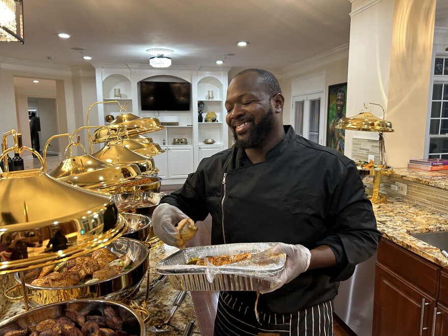 Chef Michel Odukoya plates the food at a private fundraiser in Bowie's Woodmoor neighborhood. It is one of the most affluent Black communities in the country.