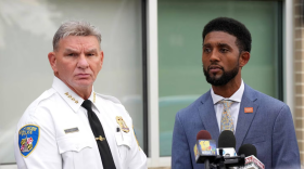 Baltimore Police Commissioner Richard Worley, left, and Baltimore Mayor Brandon Scott take questions from reporters outside Bay-Brook Elementary/Middle School in Brooklyn. A community survey found widespread dissatisfaction in how the city is policed. (Ulysses Muñoz/The Baltimore Banner)