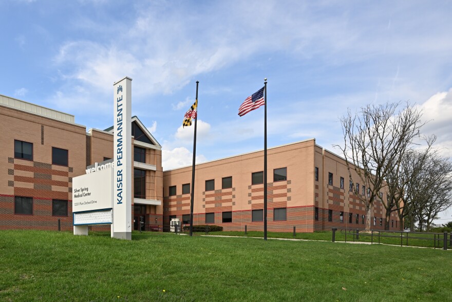 The front of the Kaiser Permanente Silver Spring Medical Center with sign and entrance. 12201 Plum Orchard Drive, Silver Spring, Maryland 20904. Credit: G. Edward Johnson, CC BY 4.0 <https://creativecommons.org/licenses/by/4.0>, via Wikimedia Commons