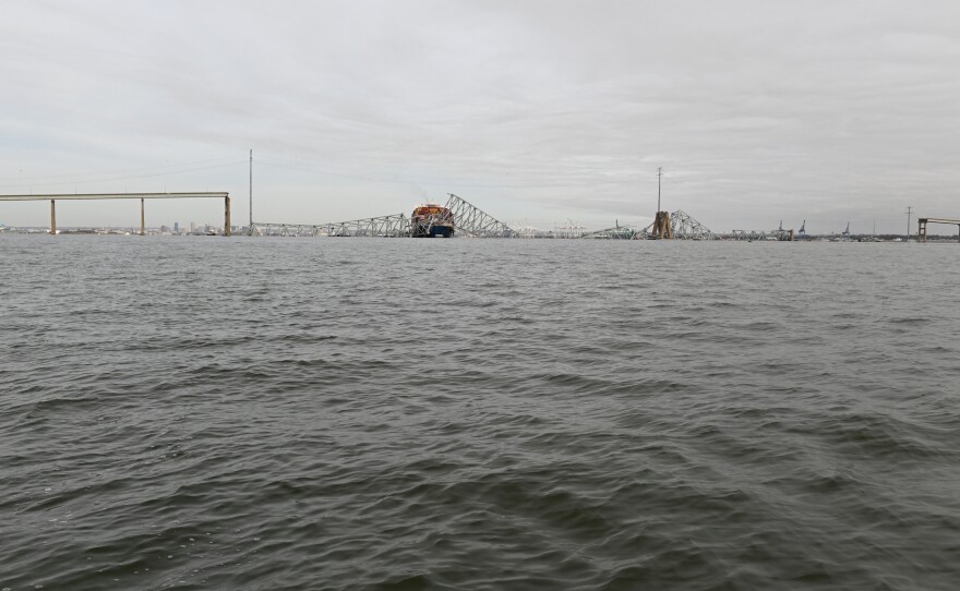 The steel frame of the Francis Scott Key Bridge sits on top of the container ship Dali after the bridge collapsed in Baltimore on Tuesday.