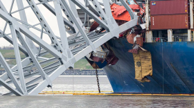 The site of the collapsed Key Bridge and the container ship that toppled it, The Dali, are seen from a debris retrieval vessel, The Reynolds, on April 4, 2024. (Kaitlin Newman/The Baltimore Banner)