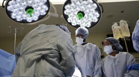 Meharry Medical College students Emmanuel Kotey, center, and Teresa Belledent, right, watch as the liver and kidneys are removed from an organ donor June 15, 2023, in Jackson, Tenn. They’re part of a novel pilot program to encourage more Black and other minority doctors-to-be to get involved in the transplant field, increasing the trust of patients of color. (AP Photo/Mark Humphrey)