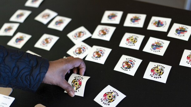 A voter gets a voting sticker after casting her ballot at Galway Elementary School, during Election Day on Tuesday, Nov. 8, 2022, in Silver Spring, Md. ( AP Photo/Jose Luis Magana)