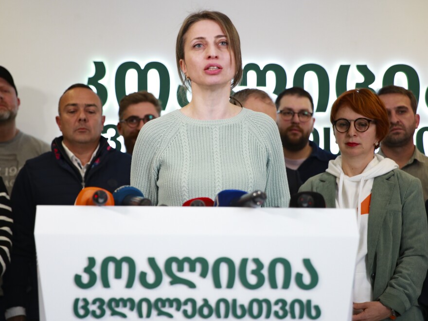 Nana Malashkhia, who leads the Coalition for Change parliament list, center, speaks to the media at coalition's headquarters after the parliamentary election in Tbilisi, Georgia on Sunday.