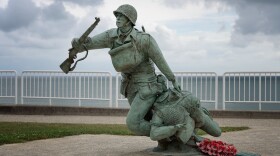 This statue by artist Yannec Tomada commemorates the 116th Infantry Regimental Combat Team, who stormed Omaha Beach on D-Day in the beginning of the liberation of Europe. The plaque reads: Ever Forward In commemoration of the determined effort by the soldiers of the 29th Division's 116th Infantry Regimental Combat Team who landed the morning of June 6, 1944 on this section of Omaha Beach, known as Exit D-1, to open the Vierville Draw behind you to begin the liberation of Europe.