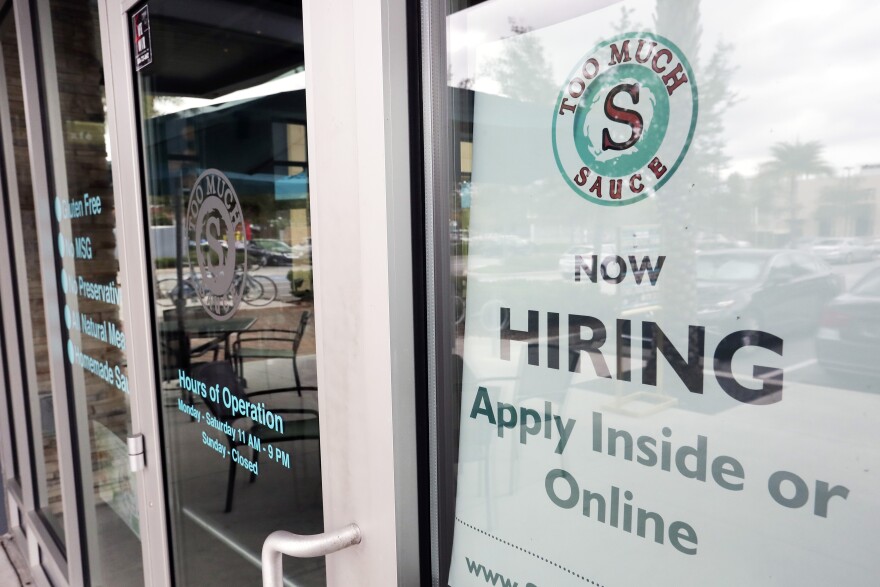 FILE - In this Nov. 4, 2019, file photo a job posting is displayed near the entrance outside a restaurant in Orlando, Fla. Two reports last week show that small business hiring still lags behind the strong job growth reported at larger companies, and that owners are unlikely to increase their staffs significantly in 2020. (AP Photo/John Raoux, File)