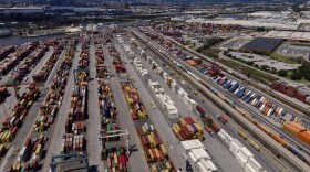 Shipping containers are stacked together at the Port of Baltimore, Friday, Aug. 12, 2022, in Baltimore. (AP Photo/Julio Cortez)