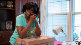 Jayne Felton rests her arms on her box of paperwork related to her sister’s care in her home office in Havre De Grace on June 8, 2023. (Heather Diehl/The Baltimore Banner)