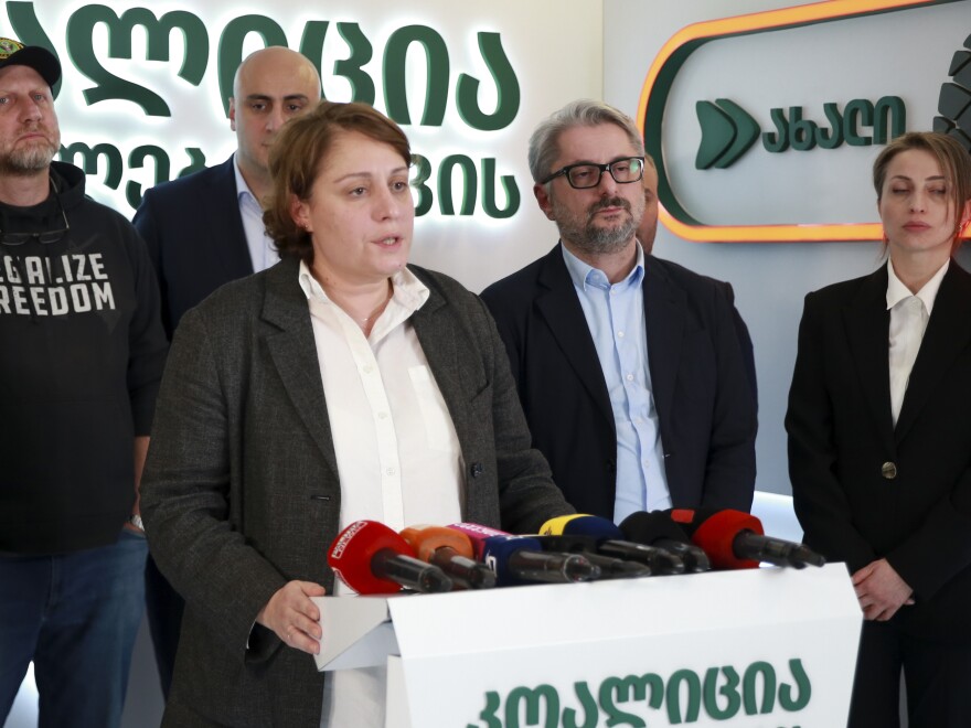 Elene Khoshtaria, chair of United National Movement, center, speaks to the media, accompanied by Zurab Japaridze, chairman of the Girchi More Freedom party, left; Nika Melia, a leader of Coalition for Changes, second left; Nika Gvaramia, leader of Coalition for Change, second right, and Nana Malashkhia, of Coalition for Change, right, in Tbilisi, Georgia, Sunday, Oct. 27, 2024.