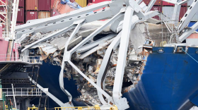 Wreckage from the collapsed Francis Scott Key bridge is seen on top of the cargo ship Dali from a boat in the Patapsco River on April 25, 2024. (Ulysses Muñoz/The Baltimore Banner)