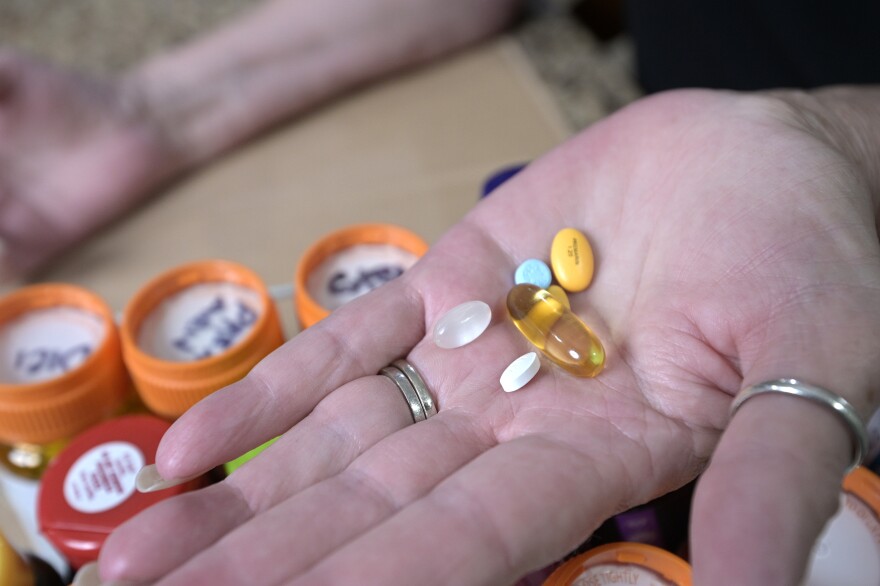 Retiree Donna Weiner shows some of the daily prescription medications that she needs and pays over $6,000 a year through a Medicare prescription drug plan at her home, Tuesday, Oct. 5, 2021, in Longwood, Fla. (AP Photo/Phelan M. Ebenhack)