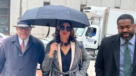 Former Baltimore State’s Attorney Marilyn Mosby arrives in court flanked by her attorney, A. Scott Bolden, left, and husband, City Council President Nick Mosby.