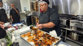 Taecharne White puts finishing touches on salmon as part of a Dignity Plates Culinary Training Academy class. Photo: Melissa Gerr