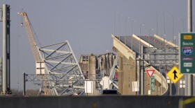 A crane is seen near the wreckage of the Francis Scott Key Bridge on Friday, March 29, 2024 in Baltimore. A cargo ship rammed into the major bridge in Baltimore early Tuesday, causing it to collapse in a matter of seconds. (AP Photo/Steve Ruark)