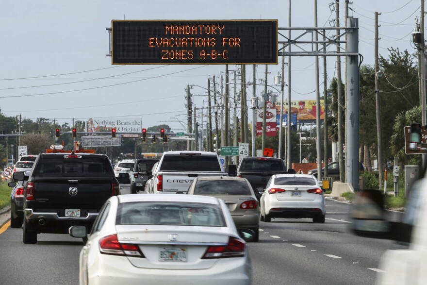 Highway signage announces the impending arrival of Hurricane Milton and the evacuations zones on Tuesday, Oct. 8, 2024, in Port Richey, Fla. (AP Photo/Mike Carlson)