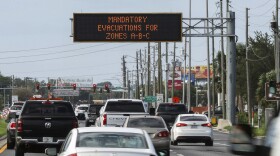 Highway signage announces the impending arrival of Hurricane Milton and the evacuations zones on Tuesday, Oct. 8, 2024, in Port Richey, Fla. (AP Photo/Mike Carlson)