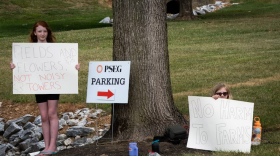 Children are seen holding signs opposing the Maryland Piedmont Reliability Project in Carroll County at a public information session held at the Westminster Senior Center on July 11, 2024. (Ronica Edwards/The Baltimore Banner)