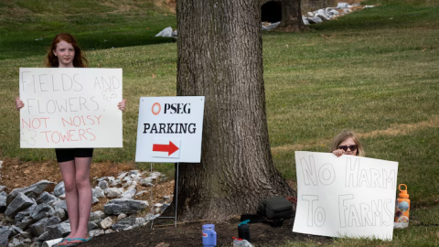 Children are seen holding signs opposing the Maryland Piedmont Reliability Project in Carroll County at a public information session held at the Westminster Senior Center on July 11, 2024. (Ronica Edwards/The Baltimore Banner)