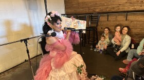 Drag Queen V.V. Majesty reads Julian is a Mermaid  at Peabody Heights Brewery during the Waverly Book Festival on April 29. Photo by Scott Maucione/WYPR.