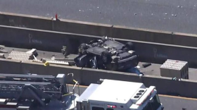 In this photo from March 22, 2023, a car sits overturned in a construction zone on the Interstate 695 inner loop after a crash that killed six construction workers. (Courtesy of WJZ-TV.)