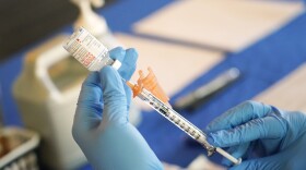 FILE - A nurse prepares a syringe of a COVID-19 vaccine at an inoculation station in Jackson, Miss., July 19, 2022. U.S. health officials are proposing a simplified approach to COVID-19 vaccinations, which would allow most adults and children to get a once-a-year shot to protect against the mutating virus. The new system unveiled Monday, Jan. 23, 2023 would make COVID-19 inoculations more like the annual flu shot. Americans would no longer have to keep track of how many shots they’ve received or how many months it’s been since their last booster. (AP Photo/Rogelio V. Solis, File)