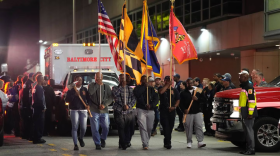 A flag processional leads an ambulance away from the Maryland Shock Trauma Center on Oct. 19. (Kylie Cooper/The Baltimore Banner)