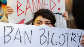 Gabriella Monroe holds a poster that says “Ban Bigotry Not Books” outside Howard County’s Central Branch library in Columbia on Feb. 26.