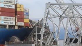 Remains of the Francis Scott Key Bridge are seen on top of the Dali, the cargo vessel that struck a supportive pylon, causing the bridge to collapse, on April 4, 2024. Authorities estimate that 4,000 tons of steel from the bridge sit on top of the ship. Photo by Scott Maucione/WYPR.