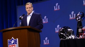 NFL Commissioner Roger Goodell standing at a podium reading "NFL" in 2017.